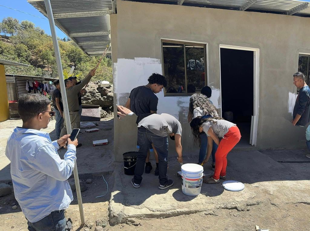 team painting a house
